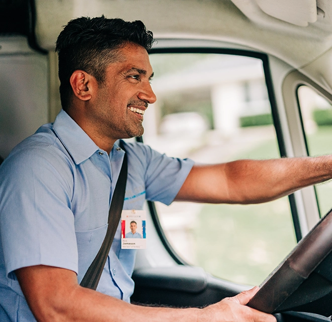 An asv technician driving van.