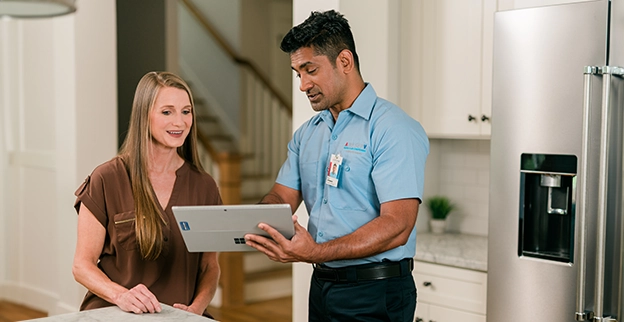 Aire Serv technician explaining services.