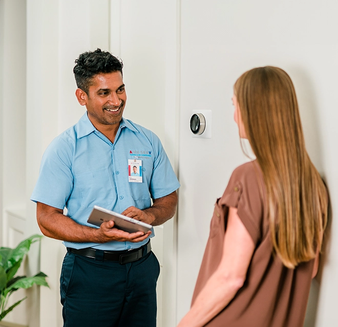 Aire Serv technician explaining various dehumidifier repair options to the customer.