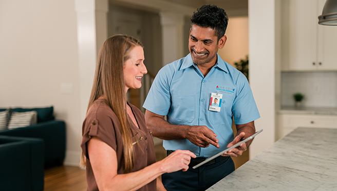 Aire Serv technician with the customer.