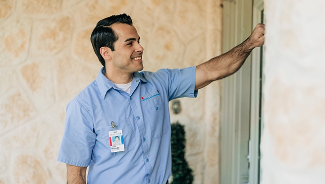 Aire Serv professional knocking on the door.