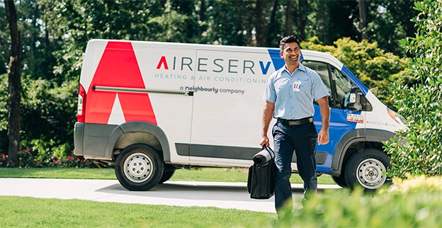 An asv technician walking to the clients house.