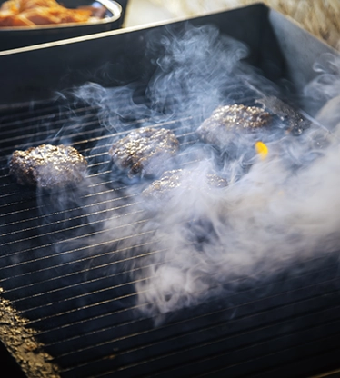Burgers on an indoor grill.