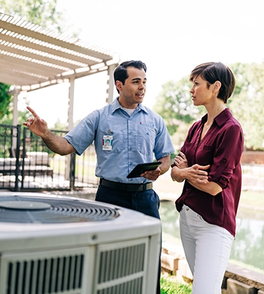 Aire serv technician explaining repairs.