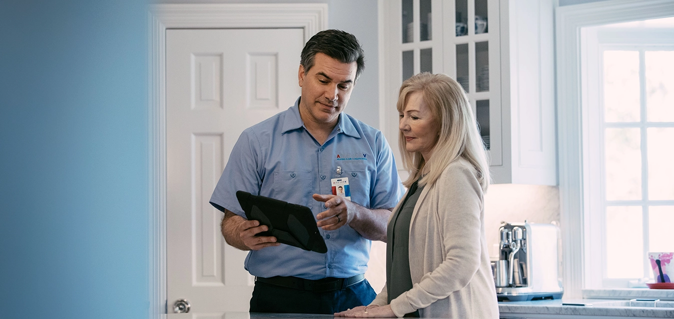 Aire serv technician explaining services to the customer.