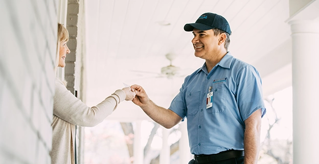 Aire serv technician greeting the customer.