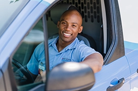 Aire Serv technician smiling inside vehicle.