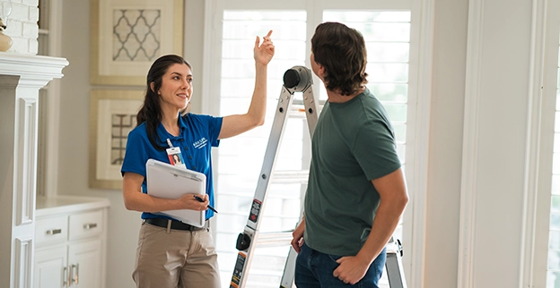 Aire Serv technician explaining air filter installation and repairs.