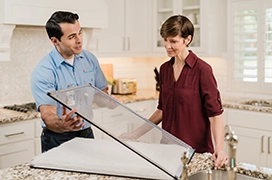 Aire Serv technician showing glass door window.