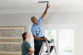 An Aire Serv technician talking to a customer.