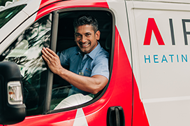 Aire Serv tech smiling in branded van.