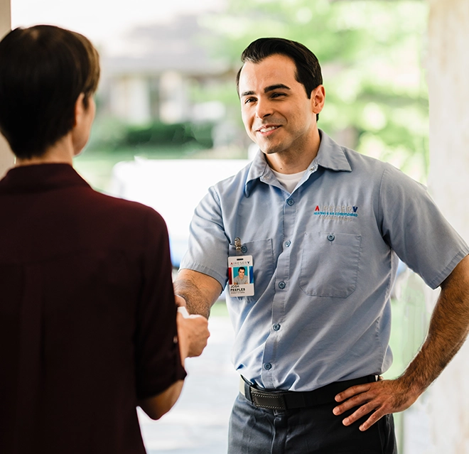 Aire Serv Professional greeting a customer.