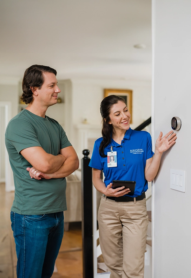 Aire Serv client talking with an Aire Serv professional.