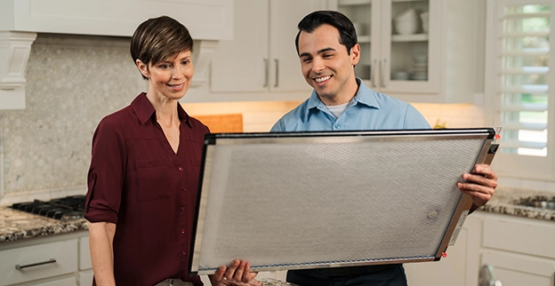 Aire Serv Professional talking with client.