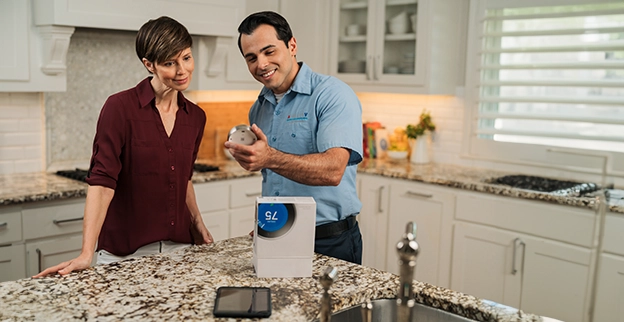 Aire Serv professional talking with a customer.