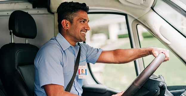 Aire Serv Professional driving and smiling.