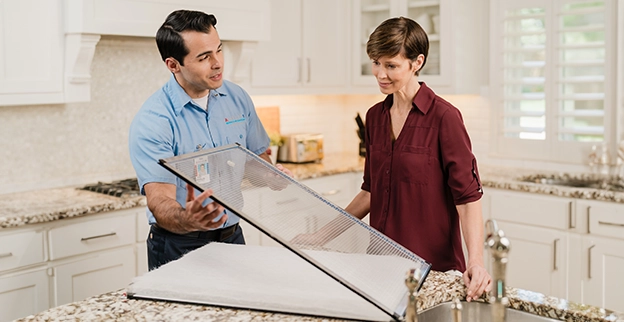 Aire Serv professional speaking with a client.