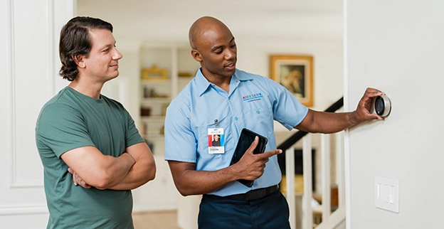 Aire Serv professional speaking with client.