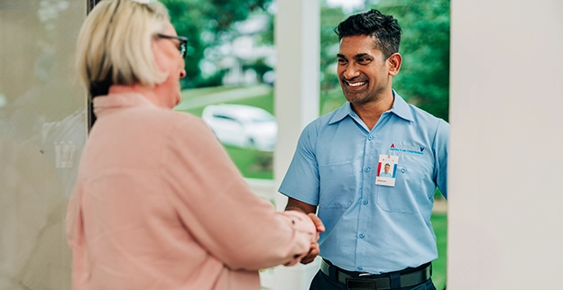 Aire Serv professional talking with a customer.